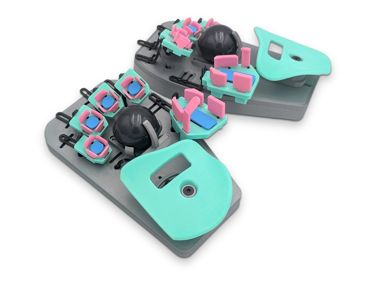 Both halves of a Svalboard Lightly in gray with mint palm rests and pink keys, each with a black trackball