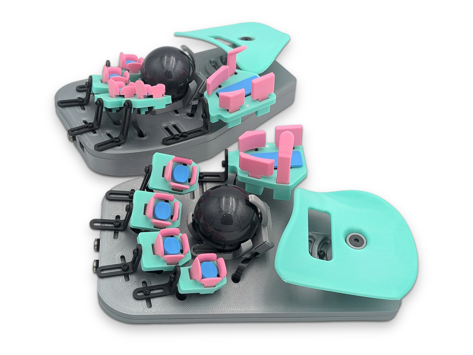 Two Svalboard Lightly halves, one behind the other, with pink keys on mint clusters, black trackballs and mint palm rests