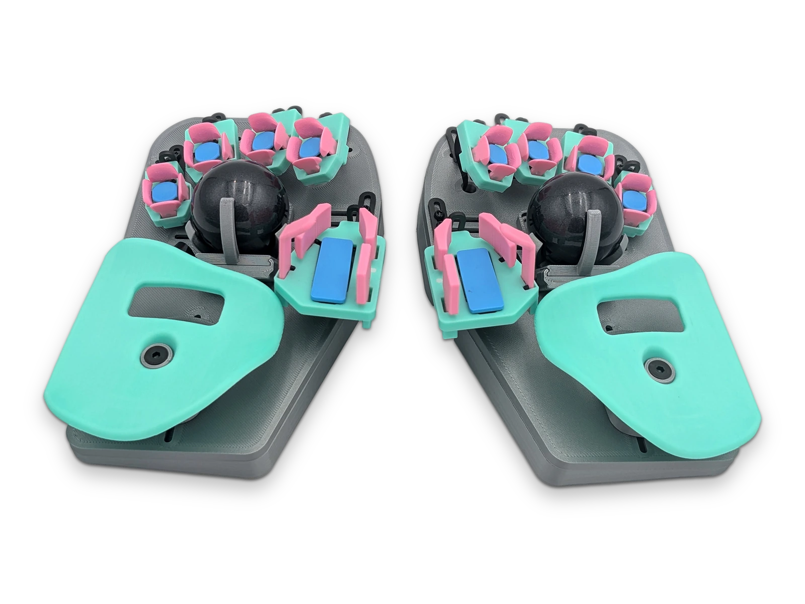 Left and right Svalboard Lightly halves side by side, from the front, with mint palm rests, pink and blue keys and black trackballs